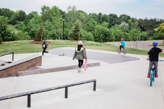 Kids skating and biking in skate park