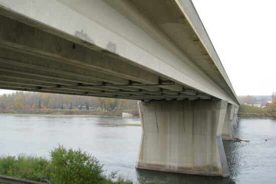 Underside of a bridge over a river
